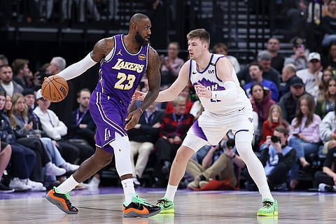 Los Angeles Lakers forward Lebron James (23) looks for the play against Utah Jazz forward Kyle Filipowski, right, during the second half of an NBA basketball game, in Salt Lake City. 