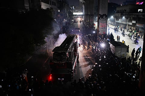 A fire engine arrives at the premises of The Daily Star newspaper after angry protesters set it on fire after news reached the country from Singapore of the death of a prominent activist Sharif Osman Hadi, in Dhaka, Bangladesh.