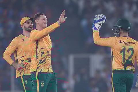 South Africa's George Linde, second from left, celebrates with teammates the dismissal of India's Sanju Samson during the fifth T20 cricket match between India and South Africa in Ahmedabad.