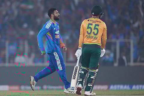India's Varun Chakaravarthy celebrates the dismissal of South Africa's Donovan Ferreira during the fifth T20 cricket match between India and South Africa in Ahmedabad.