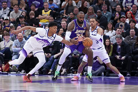 Los Angeles Lakers forward Lebron James (23) has the ball knocked away by Utah Jazz guard Ace Bailey, left as guard Keyonte George (3) defends during the second half of an NBA basketball game, in Salt Lake City. 