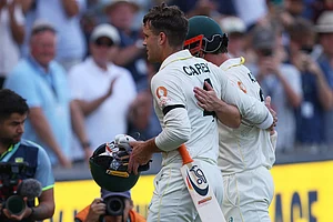 | Photo: AP/James Elsby : Australia's not out batsmen Alex Carey, left, and Travis Head leave the field at the end of play on day three of the third Ashes cricket test between England and Australia in Adelaide, Australia.