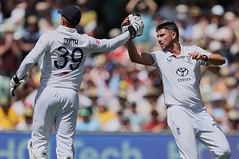 England's Josh Tongue, is congratulated by teammate Jamie Smith, left, after taking the wicket of Australia's Cameron Green during play on day three of the third Ashes cricket test between England and Australia in Adelaide, Australia.