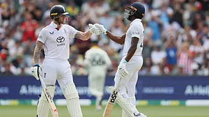 AP : Jofra Archer, right, and Ben Stokes react during play on day three of the third Ashes cricket Test.