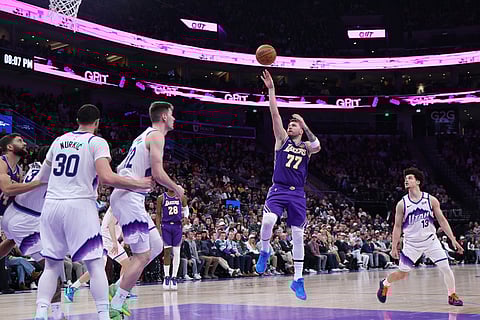 Los Angeles Lakers guard Luka Doncic (77) shoots against the Utah Jazz during the first half of an NBA basketball game in Salt Lake City. 