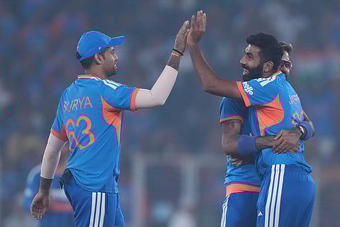 India's Jasprit Bumrah, right, celebrates with captain Suryakumar Yadav, left, the dismissal of South Africa's Quinton de Kock during the fifth T20 cricket match between India and South Africa in Ahmedabad.