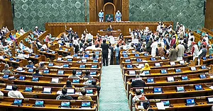 THIRD PARTY IMAGE; SCREENGRAB VIA SANSAD TV : Opposition MPs protest in the well as Union Minister Shivraj Singh Chouhan (unseen) speaks in the Lok Sabha during the Winter session of Parliament