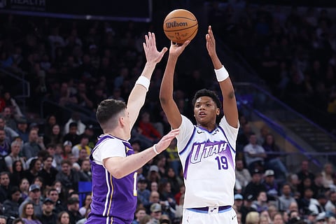 Utah Jazz guard Ace Bailey (19) looks. to shoot a 3-point basket over Los Angeles Lakers forward Jake Laravia, left, during the second half of an NBA basketball game, in Salt Lake City. 
