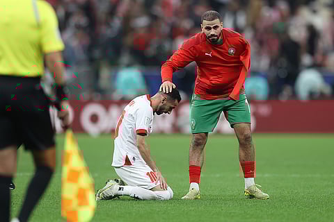 Morocco's Oussama Tannane, right, consoles Jordan's Ahmad Hamdouni at the end of the FIFA Arab Cup final soccer match between Jordan and Morocco in Lusail, Qatar.