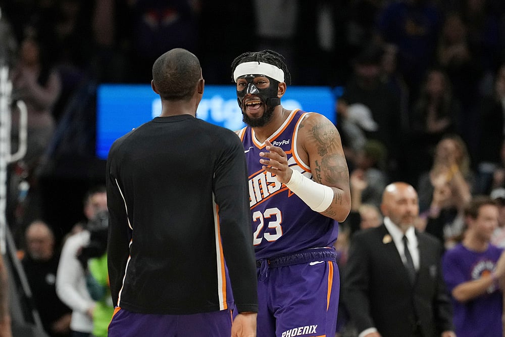 Phoenix Suns guard Jordan Goodwin (23) celebrates his game-winning free throw against the Golden State Warriors with Suns guard Jamaree Bouyea as time expires during the second half of an NBA basketball game in Phoenix.  - | Photo: AP/Ross D. Franklin