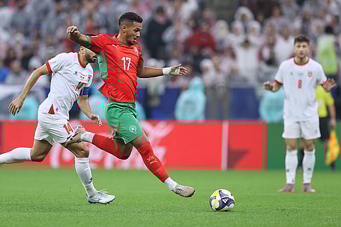 Morocco's Mounir Chouiar, right, runs after the ball next to Jordan's Rajaei Ayed during to the FIFA Arab Cup final soccer match between Jordan and Morocco in Lusail, Qatar.