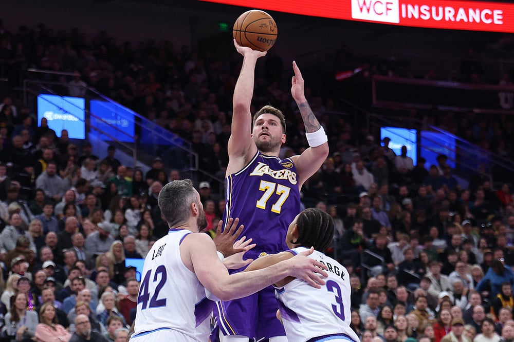 Los Angeles Lakers guard Luka Doncic (77) shoots over Utah Jazz forward Kevin Love (42) and guard Keyonte George (3) during the second half of an NBA basketball game, in Salt Lake City.  - | Photo: AP/Rob Gray