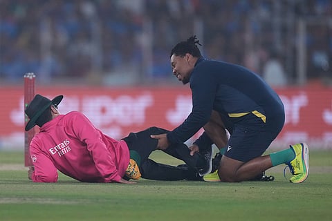 A physio, right, attend umpire Rohan Pandit hit by India's Sanju Samson during the fifth T20 cricket match between India and South Africa in Ahmedabad.