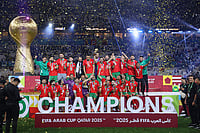 Jordan 2-3 Morocco: Abderrazzaq Hamed Allah Brace Lands FIFA Arab Cup 2025 Title | Photo: AP/Hussein Sayed : Morocco's players celebrate with the winner trophy after defeating Jordan in the FIFA Arab Cup final soccer match in Lusail, Qatar.