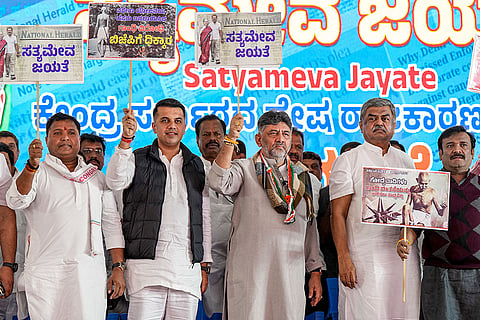 Karnataka Deputy Chief Minister and state Congress President D K Shivakumar, centre, with party leaders during a protest against the central government replacing the MGNREGA with Viksit Bharat Guarantee for Rozgar and Ajeevika Mission (Gramin) (VB-G RAM G) Bill, and alleged "hate politics" against the party leadership in the National Herald case, in Bengaluru.