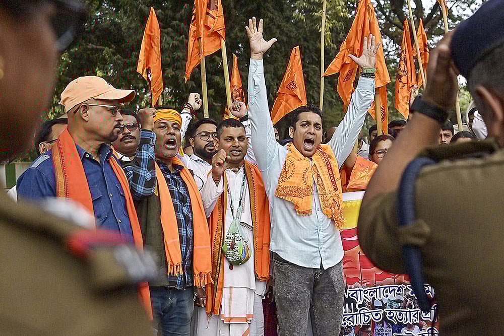 Members of 'Hindu Jagran Manch' stage a protest over the alleged lynching of a Hindu man Dipu Chandra Das in Bangladesh, near Bangladesh Assistant High Commission, in Agartala. - | Photo: PTI 