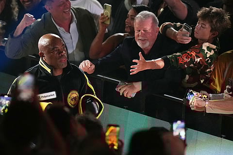 Anderson Silva, left, walks to the ring before his cruiserweight fight against Tyron Woodley in Miami.