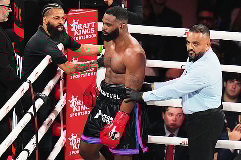 Tyron Woodley, center, stands in his corner after being hit by Anderson Silva during their cruiserweight fight in Miami.