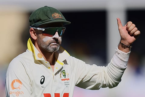 Australia's Nathan Lyon gestures to the crowd after taking the wicket of England's Zak Crawley during play on day four of the third Ashes cricket test between England and Australia in Adelaide, Australia.