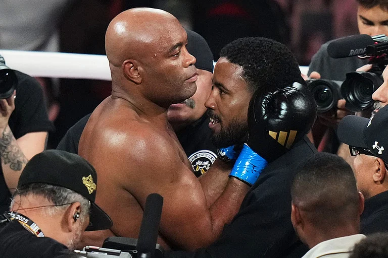 Anderson Silva, center left, is embraced after his knockdown of Tyron Woodley during their cruiserweight fight in Miami. - | Photo: AP/Lynne Sladky
