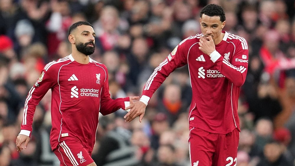 Liverpool's Mohamed Salah, left, and Liverpool's Hugo Ekitike greet each other during the English Premier League soccer match between Liverpool and Brighton and Hove Albion in Liverpool, England. - | Photo: AP/Jon Super