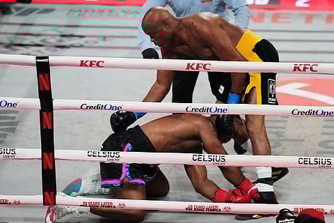 Tyron Woodley, bottom, falls to the canvas after being hit by Anderson Silva, top, during their cruiserweight fight in Miami.