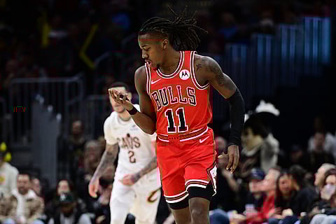Chicago Bulls guard Ayo Dosunmu celebrates after making a three-point basket in the second half of an NBA basketball game against the Cleveland Cavaliers in Cleveland. 
