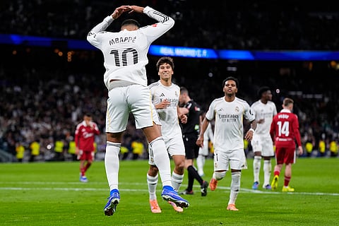Real Madrid's Kylian Mbappe celebrates after scoring his side second goal from the penalty spot during the Spanish La Liga soccer match between Real Madrid and Sevilla in Madrid, Spain.