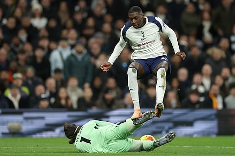 Liverpool's goalkeeper Alisson makes a save in front of Tottenham's Randal Kolo Muani during the English Premier League soccer match between Tottenham and Liverpool in London.