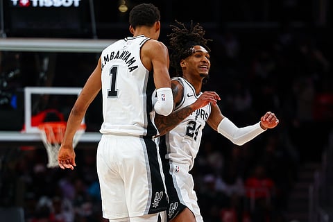 San Antonio Spurs forward Victor Wembanyama (1) and guard Devin Vassell, right, react during the second half of an NBA basketball game against the Atlanta Hawks in Atlanta. 