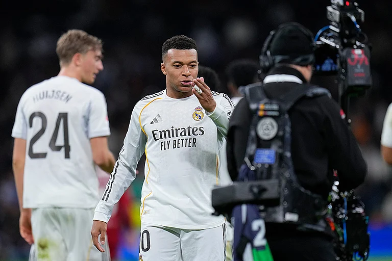 Real Madrid's Kylian Mbappe blows a kiss towards the TV camera as he celebrates after scoring his sides second goal during the Spanish La Liga soccer match between Real Madrid and Sevilla in Madrid, Spain. - | Photo: AP/Manu Fernandez