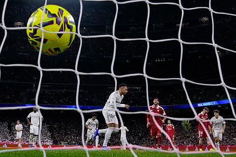 Real Madrid's Kylian Mbappe runs off to celebrate after scoring his sides second goal from the penalty spot during the Spanish La Liga soccer match between Real Madrid and Sevilla in Madrid, Spain.