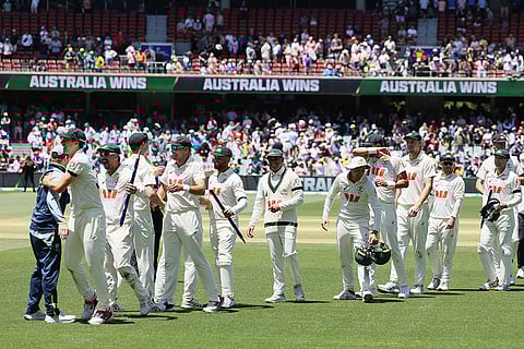 Australia's players celebrate after winning the third Ashes Test against England in Adelaide, Australia.