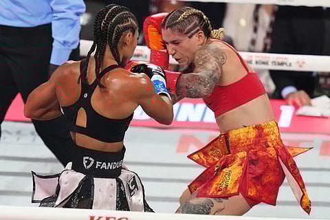 Alycia Baumgardner, left, and Lela Beaudoin, right, compete during their super-featherweight fight in Miami.