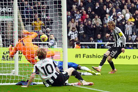 Newcastle's Nick Woltemade, right, scores the opening goal during the English Premier League soccer match between Newcastle United and FC Chelsea in Newcastle, England.