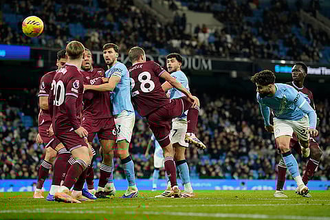 Manchester City's Josko Gvardiol, right heads the ball towards goal, during the English Premier League soccer match between Manchester City and West Ham United in Manchester, England.