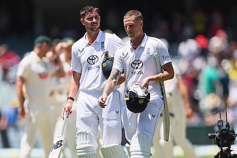 England's Josh Tongue, left, and England's Brydon Carse walk back after losing the third Ashes Test match against Australia in Adelaide. Australia.