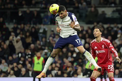 Tottenham's Cristian Romero, left, duels for the ball with Liverpool's Hugo Ekitike during the English Premier League soccer match between Tottenham and Liverpool in London.