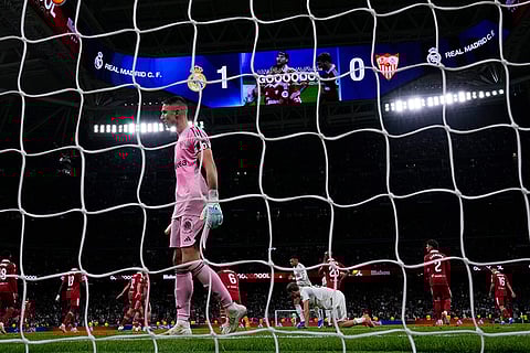 Sevilla's goalkeeper Odysseas Vlachodimos reacts after Real Madrid's Jude Bellingham scored the opening goal during the Spanish La Liga soccer match between Real Madrid and Sevilla in Madrid, Spain.