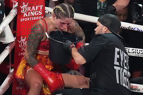 Lela Beaudoin spits into a bucket during her super-featherweight fight against Alycia Baumgardner in Miami.