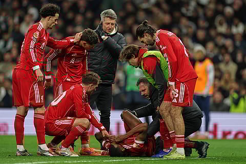 Liverpool's Alexander Isak reacts after sustaining an injury during the English Premier League soccer match between Tottenham and Liverpool in London.