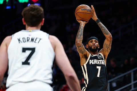 Atlanta Hawks guard Nickeil Alexander-Walker (7) looks to shoot while San Antonio Spurs center Luke Kornet (7) defends during the first half of an NBA basketball game in Atlanta. 