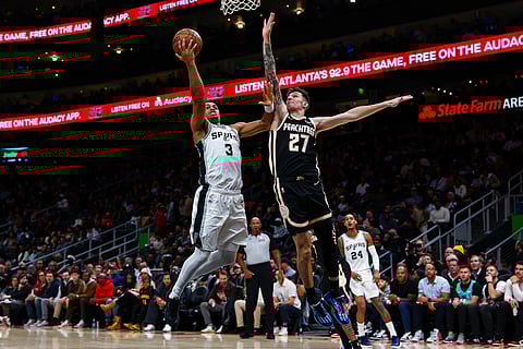 San Antonio Spurs forward Keldon Johnson (3) goes up to shoot against Atlanta Hawks guard Vit Krejci (27) during the second half of an NBA basketball game in Atlanta. 