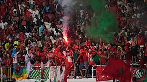 | Photo: AP/Sunday Alamba : Morocco supporters light flares during the African Cup of Nations Group F soccer match between Morocco and Zambia at the Laurent Pokou Stadium in San Pedro, Ivory Coast, Jan. 24, 2024.