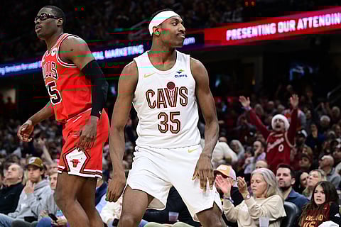 Cleveland Cavaliers forward Nae'Qwan Tomlin (35) celebrates after making a 3-point basket in the second half of an NBA basketball game against the Chicago Bulls in Cleveland. 