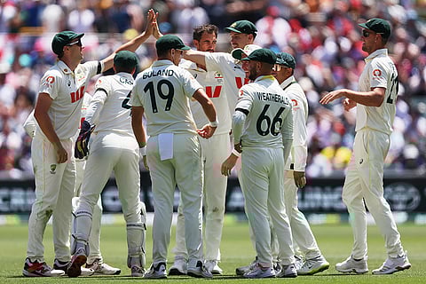Australian players celebrate the dismissal of England's Jamie Smith during play on the final day of the third Ashes cricket test between England and Australia in Adelaide, Australia.