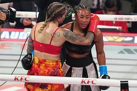 Lela Beaudoin, left, and Alycia Baumgardner, right, embrace after their super-featherweight fight in Miami.