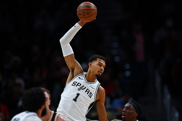 San Antonio Spurs forward Victor Wembanyama (1), grabs a pass over Atlanta Hawks forward Onyeka Okongwu, right, during the first half of an NBA basketball game in Atlanta. - | Photo: AP/Colin Hubbard