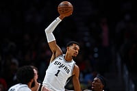 | Photo: AP/Colin Hubbard : San Antonio Spurs forward Victor Wembanyama (1), grabs a pass over Atlanta Hawks forward Onyeka Okongwu, right, during the first half of an NBA basketball game in Atlanta. 