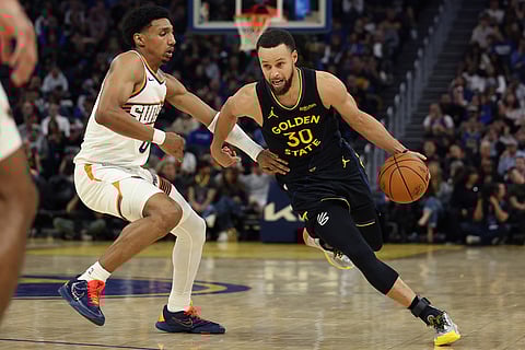 Golden State Warriors guard Stephen Curry (30) drives to the basket against Phoenix Suns forward Ryan Dunn (0) during the second half of an NBA basketball game in San Francisco.